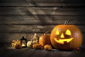 Halloween pumpkin head jack lantern on wooden background